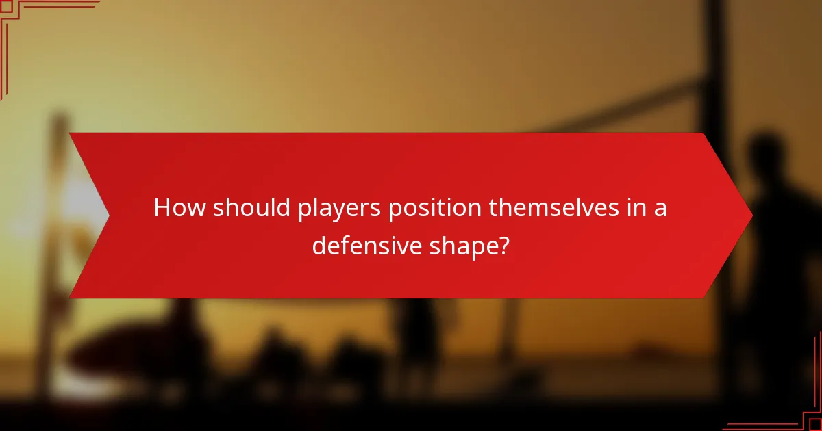How should players position themselves in a defensive shape?